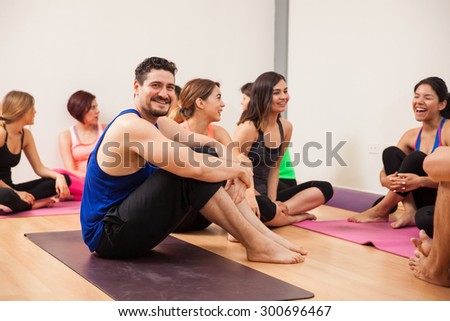 Portrait of a young man resting and socializing after an intensive yoga class