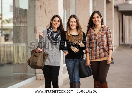 Portrait of a group of three Hispanic women walking together around a shopping mall