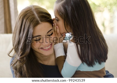 Little girl telling her mother a secret
