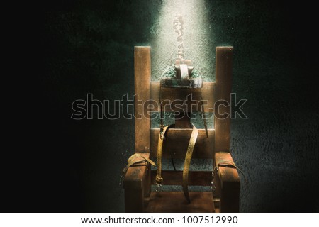 High contrast image of an electric chair scale model on a dark backgorund with light rays