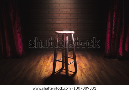 wooden stool on a stand up comedy stage with reflectors ray, high contrast image