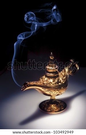 aladdin magic lamp on black with smoke