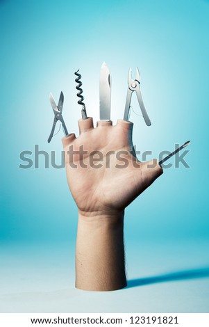 Open hand with tools on a blue background