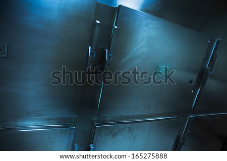 Grungy and high contrast photo of morgue trays