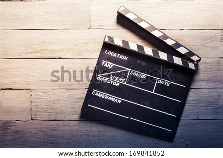 vintage photo of movie clapper on wood