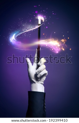 Magician hand with magic wand