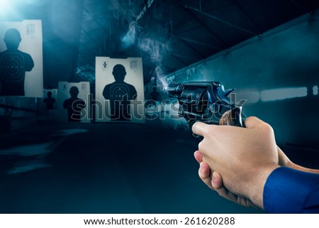 Police officer holding a gun at a shooting range