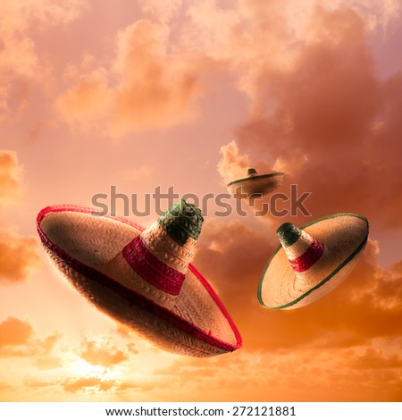 square format image of Mexican sombreros in a dramatic orange sky