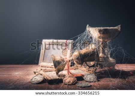 High contrast image of dusty trophies with cobwebs representing broken or abandoned dreams