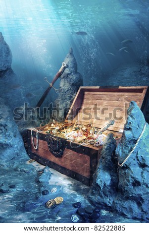 photo of open treasure chest with shinny gold underwater