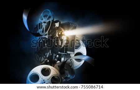 Cinema background with movie projector and film reels on a dark background / high contrast image