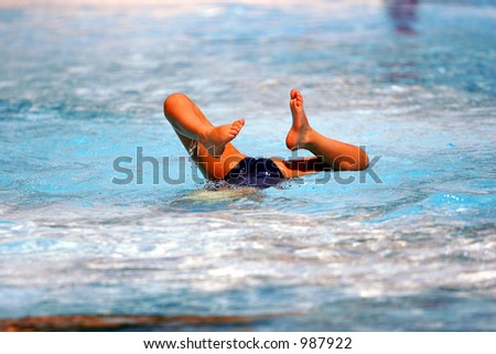 Child playing in a swimming pool(feet in the air) - MORE SIMILAR AVAILABLE, PLEASE LOOK IN MY PORTFOLIO