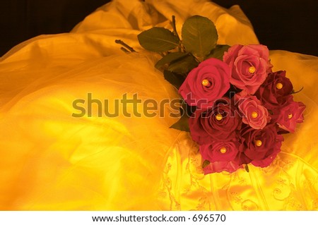 Wedding dress and roses in yellow lighting