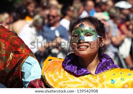 BERLIN - MAY 19: Unidentified Asian woman dressed in multicolored oriental carnival costume participates at the annual Berlin Carnival of Cultures on May 19, 2013 in Berlin.