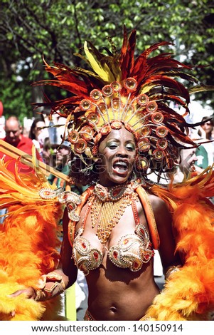 BERLIN - MAY 19: Unidentified woman samba dancer dressed in multicolored feather carnival costume performs at the annual Berlin Carnival of Cultures on May 19, 2013 in Berlin