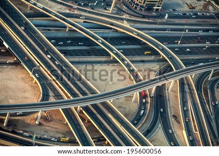 Highway roads with traffic in a big city viewed from the sky in evening