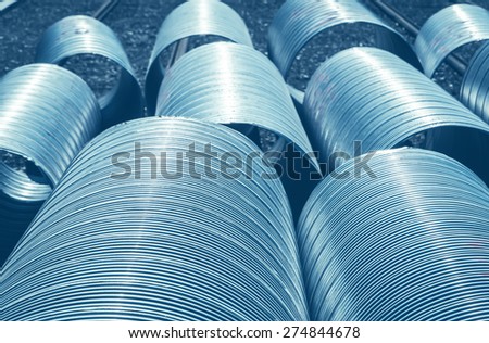 Big new metal housing pipes for city underground water heating system. Abstract background.