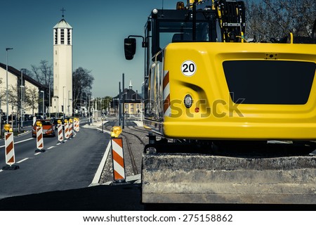 Road construction site in european city with excavator (filtered)