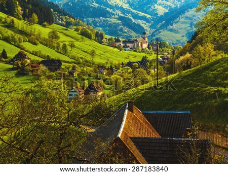 Beautiful mountain landscape with a monastery in village. Germany, Black forest, Muenstertal.