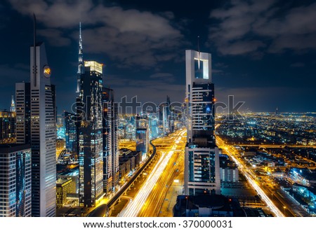 DUBAI, UAE - DECEMBER 16, 2015: Rooftop view of Sheikh Zayed road with traffic and illuminated skyscrapers. This is one of the iconic views of Dubai.