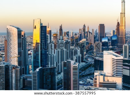 Beautiful modern city architecture at golden sunset. View of Dubai business bay towers.