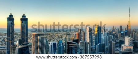 Sunset skyline with modern skyscrapers in Dubai, UAE. Aerial  view of business bay\'s architecture.
