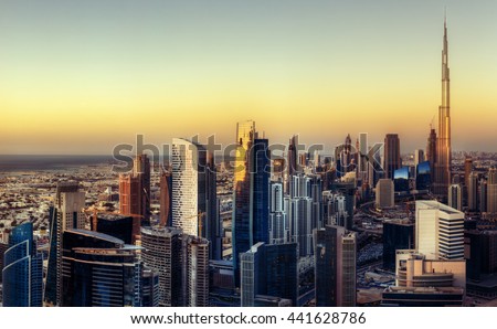 Big futuristic city at colorful sunset. Fantastic skyline of Dubai, UAE.