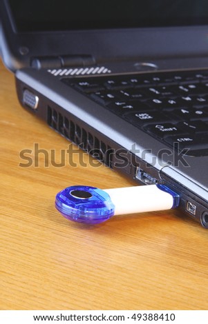 USB flash drive in the shape of a key inserted in a notebook