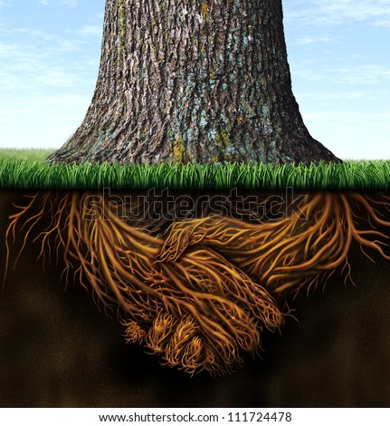 Strong deep business roots as a tree trunk with the root in the shape of a hand shake as a symbol of unity trust and integrity in finance and relationships.