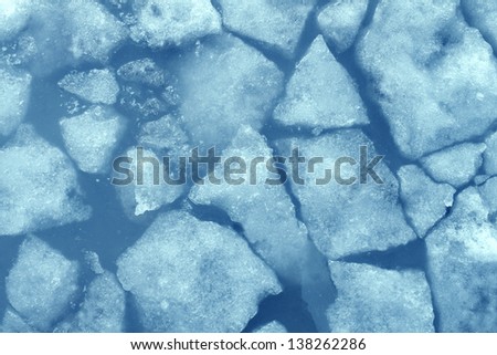 Broken ice background as a concept of blue frigid cold temperatures as in the arctic polar climate with chunks of below zero frozen water representing cool refrigerated environment.