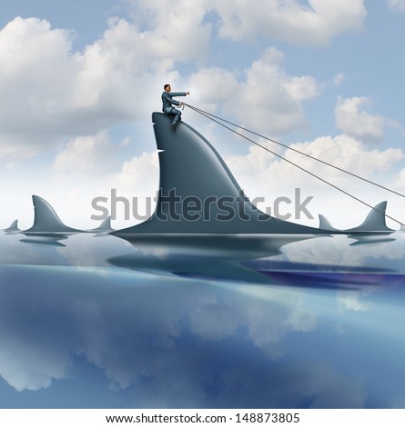 Risk control business concept with a courageous businessman riding a dangerous shark in the ocean guiding it for success controlling and managing uncertainty as a symbol of leadership .