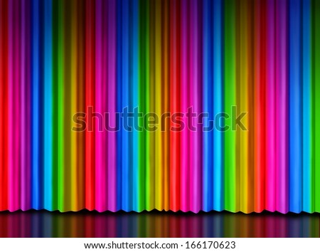 Rainbow curtain on a theater or theatre stage as a symbol of creative entertainment or important message presentation with spectrum colored drapes as red purple yellow green and blue silk material.