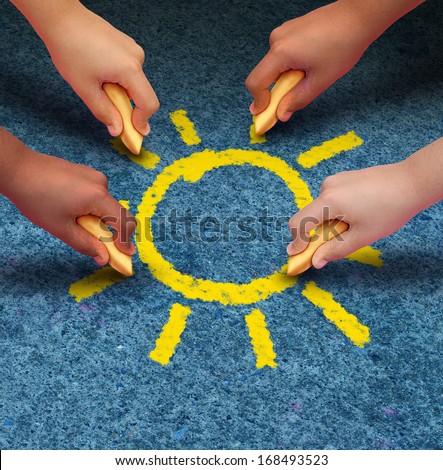 Community education and children learning and development concept with a group of hands representing ethnic groups of young people holding chalk cooperating together as friends to draw a yellow sun.
