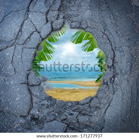Escape city stress vacation dreaming as a dirty road pothole with the magical reflection of a tropical beach paradise scene as a metaphor for leisure holiday break from urban decay anxiety.