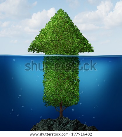 Business recovery concept as an arrow tree drowning underwater emerging to the surface rising out of the ocean as a financial symbol of  economic growth return.