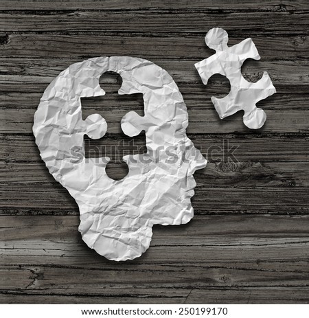 Puzzle head brain concept as a human face profile made from crumpled white paper with a jigsaw piece cut out on a rustic old wood background as a mental health symbol.