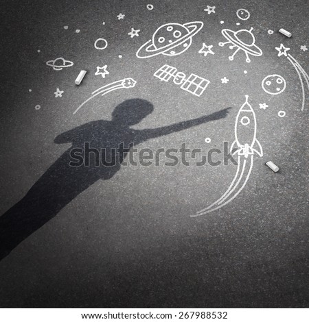 Child space dream as a childhood imagination concept with a cast shadow of a kid dreaming of being an astronaut explorer with chalk drawings of a rocket spacecraft planets stars and a flying saucer.
