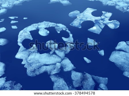 Puzzle head idea and concept as a human face profile made from floating ice floating away in water with a jigsaw piece cut out on a cold blue arctic background as a mental health symbol.
