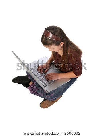 Young girl sitting on the ground while typing an email on her laptop computer