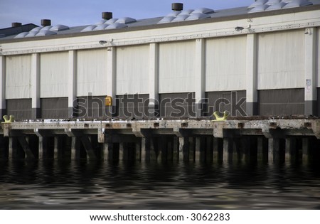 Commercial storage building on pier with reflective water