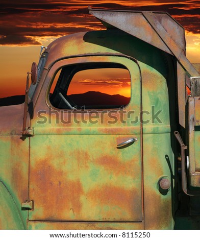Closeup of rusty farm dump truck with colorful sky