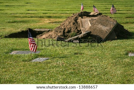 Empty grave with patriotic American flags showing pride in the USA for the holiday