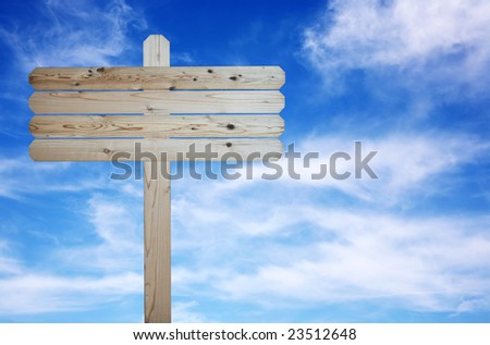 Natural wood blank sign on cloudy blue sky background