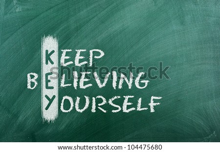 Acronym of KEY. Believe in yourself written in chalk on a blackboard .