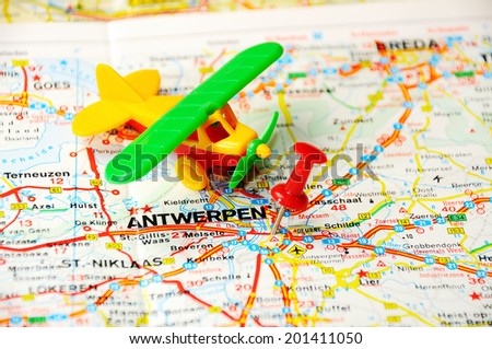Red push pin pointing at Antverpen , Belgium map   and a airplane