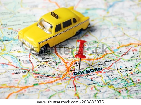 Close up of  Dresden  map with red pin and a taxi toy - Travel concept
