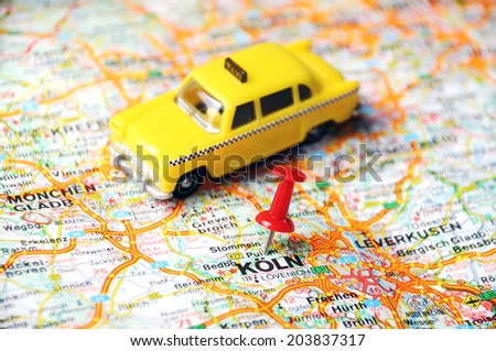 Close up of Koln ,Germany  map with red pin and a taxi - Travel concept