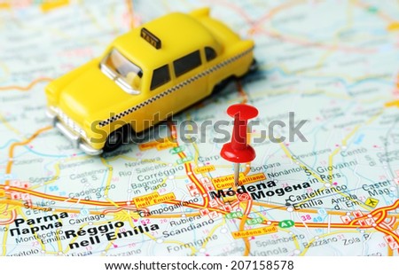 Close up of  Modena , Italy map with red pin and a taxi   - Travel concept