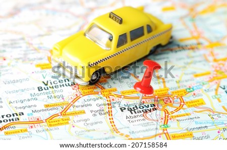 Close up of  Padua , Italy map with red pin and a taxi   - Travel concept