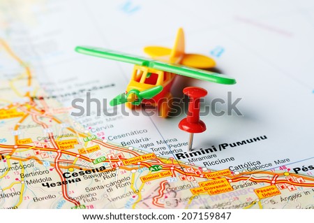 Close up of  Rimini , Italy map with red pin and airplane   - Travel concept
